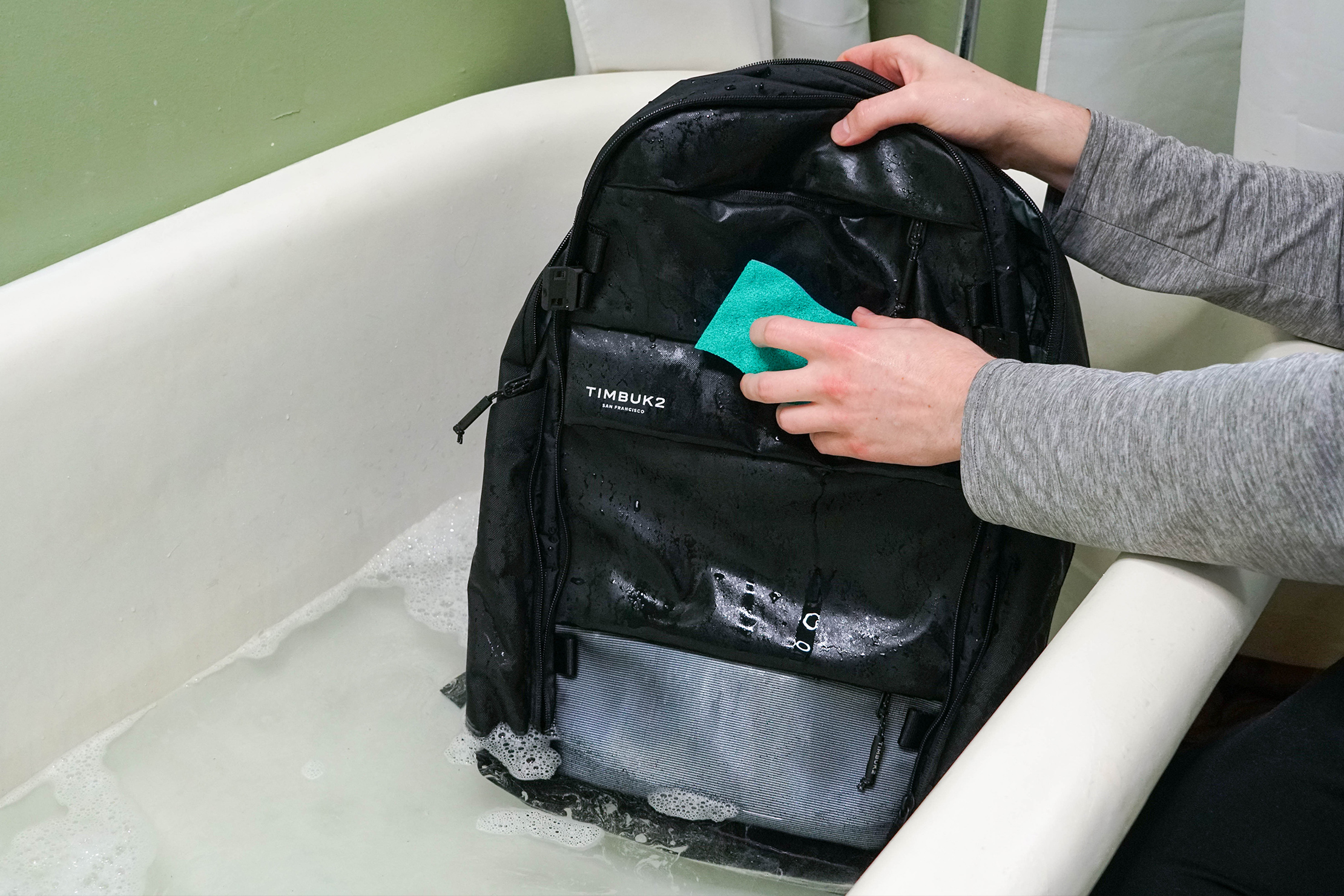 Soak your travel backpack in water and scrub it gently