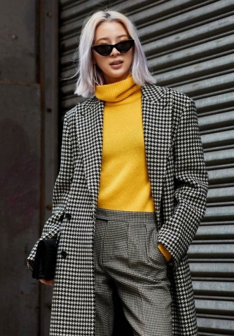 Elegant outfit coordination with mustard yellow sweater and black white gingham women's suit Elegant outfit coordination with mustard yellow sweater and black white gingham women's suit
