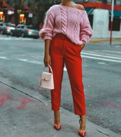 Elegant outfit pairing with pink off-shoulder sweater and red dress pants
