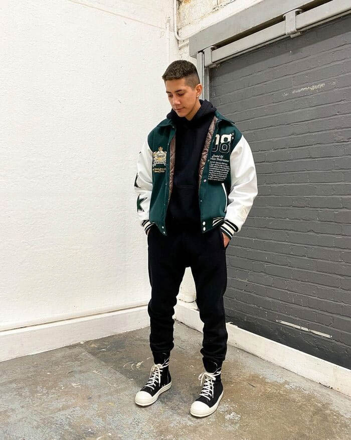Men's hoodie outfit styling with varsity jacket
