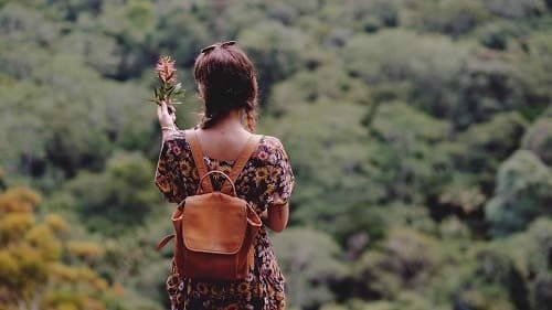 Backpack mixed with a feminine floral dress
